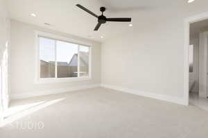 Unfurnished room featuring ceiling fan and light colored carpet