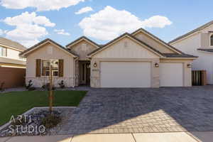 View of front of property with a front lawn and a garage