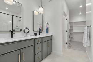 Bathroom featuring vanity and a shower with door