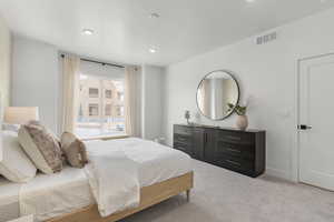 Bedroom with light colored carpet