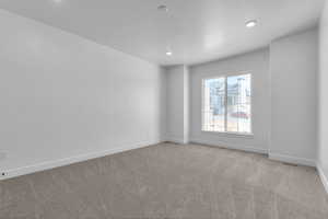 Unfurnished room featuring light carpet, baseboards, visible vents, and recessed lighting