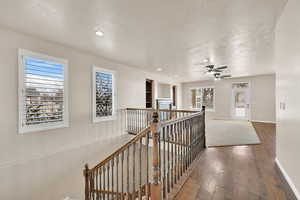 Corridor featuring hardwood / wood-style floors and a textured ceiling