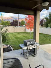 View of patio / terrace featuring ceiling fan, area for grilling, and a mountain view