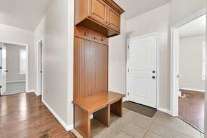 Mudroom with light tile patterned flooring