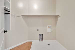 Laundry room featuring washer hookup, hookup for an electric dryer, and light tile patterned flooring