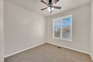 Unfurnished room with ceiling fan and carpet