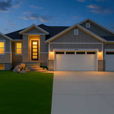 Craftsman-style home featuring a garage, board and batten siding, a front lawn, and stone siding