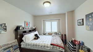 Bedroom with a textured ceiling