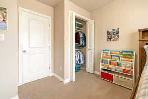 Carpeted bedroom with baseboards