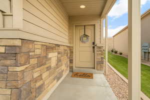 Entrance to property with stone siding