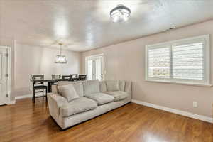Living area with a textured ceiling and wood finished floors