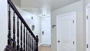 Entryway featuring light hardwood / wood-style floors and a textured ceiling