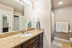 Full bathroom featuring vanity, tile patterned floors, and a shower with shower curtain