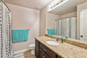 Bathroom featuring vanity, tile patterned floors, and curtained shower