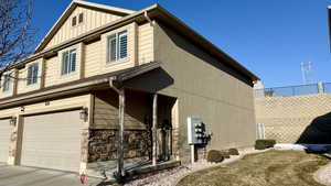 View of side of home featuring a garage