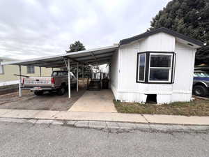 View of front of property with a carport