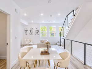 Dining area with recessed lighting, baseboards, stairway, and light wood-type flooring