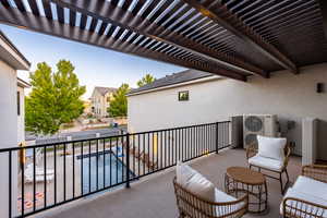 Balcony featuring a pergola and ac unit