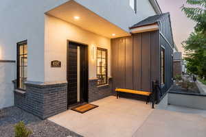 Exterior entry at dusk with a patio