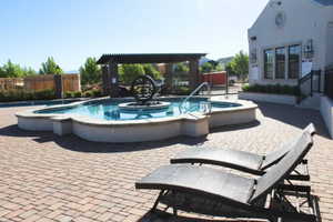 View of pool featuring a hot tub and a patio area