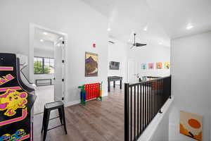 Corridor featuring light hardwood / wood-style floors and vaulted ceiling