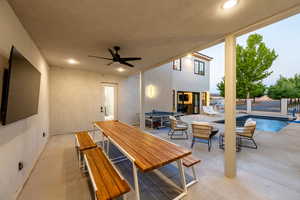 View of patio / terrace featuring a fenced in pool and ceiling fan