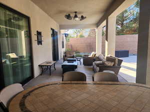 View of patio / terrace with an outdoor living space and ceiling fan