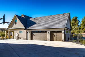 View of side of home featuring a 3 car attached garage