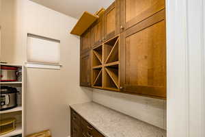 Butler's pantry with wine rack & under counter lighting.