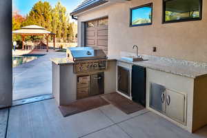 View of patio / terrace with exterior kitchen, a gazebo, and area for grilling