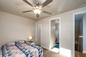 Bedroom 2 with ceiling fan, carpet, and ensuite bathroom