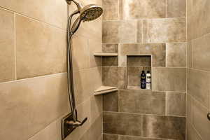 Owner's ensuite bathroom featuring a tile walk-in shower