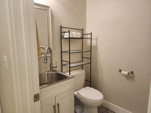 1/2 in detached garage Bathroom featuring toilet and vanity