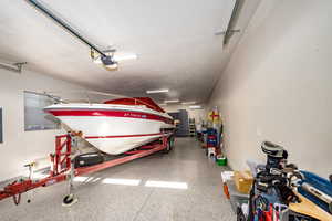 Detached 2 car tandem Garage featuring epoxy flooring and garage door opener