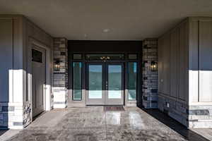 Entrance to property featuring french doors & to the left entrance to office/den.