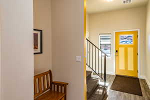 Detached garage Foyer of apartment featuring dark wood-type flooring