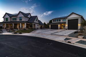 Modern farmhouse with covered porch, a garage, and solar panels