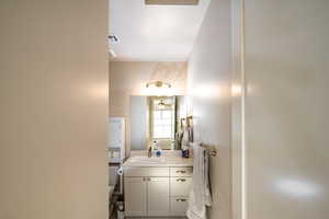 Bathroom 2 ensuite featuring toilet, a textured ceiling, and vanity