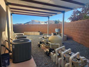 View of covered area for pool equipment and AC units.