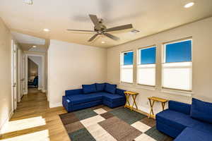 Family room featuring ceiling fan and wood-type flooring