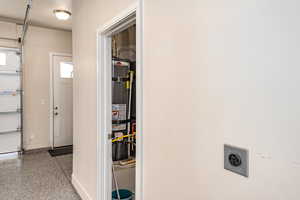 Garage utility room with secured water heater