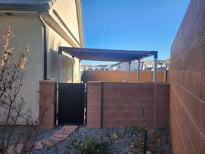 Exterior space gate from backyard to covered pool equipment area.