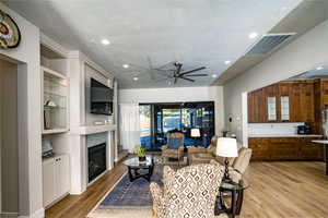 Family room featuring a textured ceiling, ceiling fan, and light hardwood / wood-style flooring