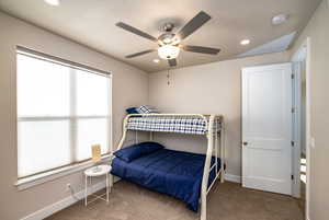 Bedroom 3 with ceiling fan, carpet, and multiple windows