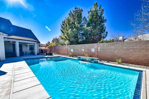 View of pool featuring pool water feature and a patio