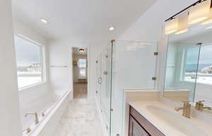 Bathroom featuring a stall shower, a garden tub, marble finish floor, a textured ceiling, and vanity