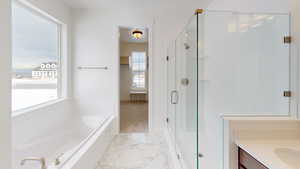 Full bathroom with a healthy amount of sunlight, a garden tub, marble finish floor, and a stall shower