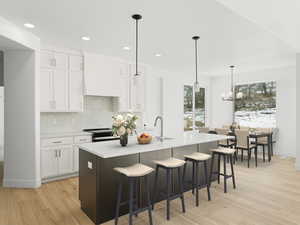 Kitchen featuring light countertops, tasteful backsplash, custom range hood, electric range, and white cabinets