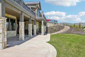 View of home's community featuring stairway, a yard, and a mountain view