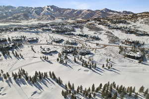 Snowy aerial view featuring a mountain view